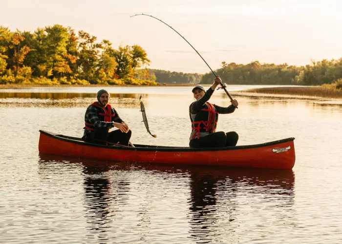Two people fishing from canoe