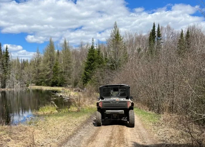 Utility Terrain Vehicle on a trail during a sunny day