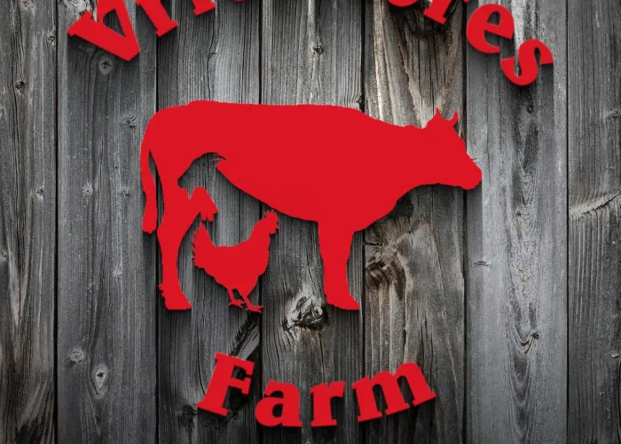 Vries Acres Logo. Red writing on a black wood background. Image includes silhouette of a cow, goat and chicken.
