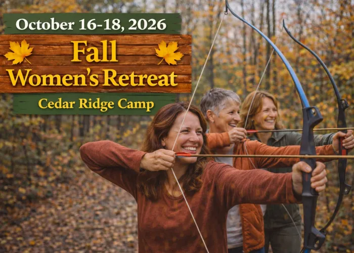 Three women in a forest, fall leaves on the trees and ground, women holding bow and arrows, name of event